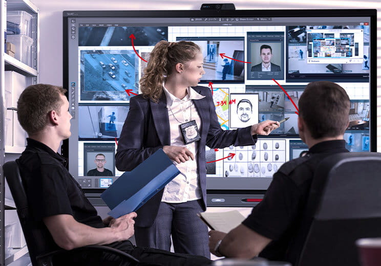 Collaboration on an investigation using a SMART Board in a law enforcement setting.